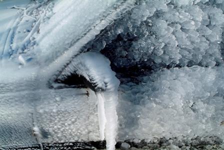 Car door frozen shut by winter ice. Ice can cause damage to your weather stripping. 