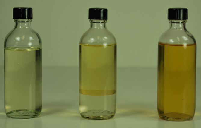 three bottles depicting the stages of oil separation
