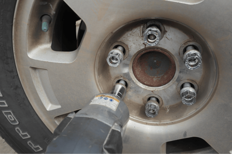 Then remove the lug nuts and store them in the center cap.