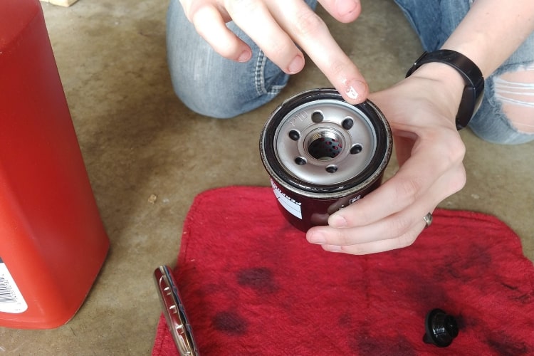 Ensure a good seal by applying oil to new oil filter o-ring.