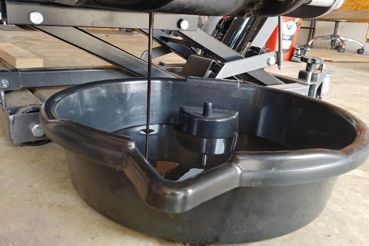 An oil drain pan is a must when changing motorcycle oil.