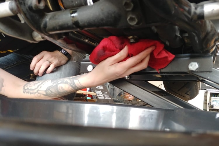 Keep the area clean by wiping away any excess oil from the motorcycle oil pan.