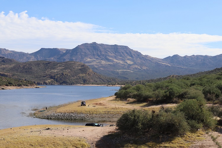 landscape of desert with stream and hills in background