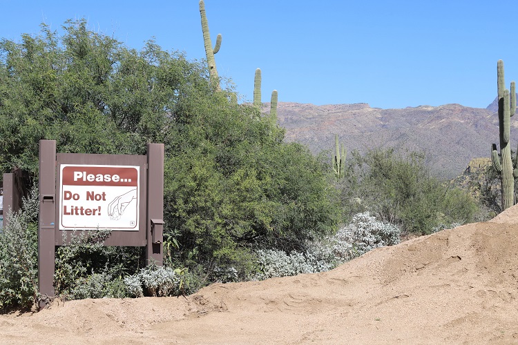 sign in front of an overlook that reads 'please... do not litter!'