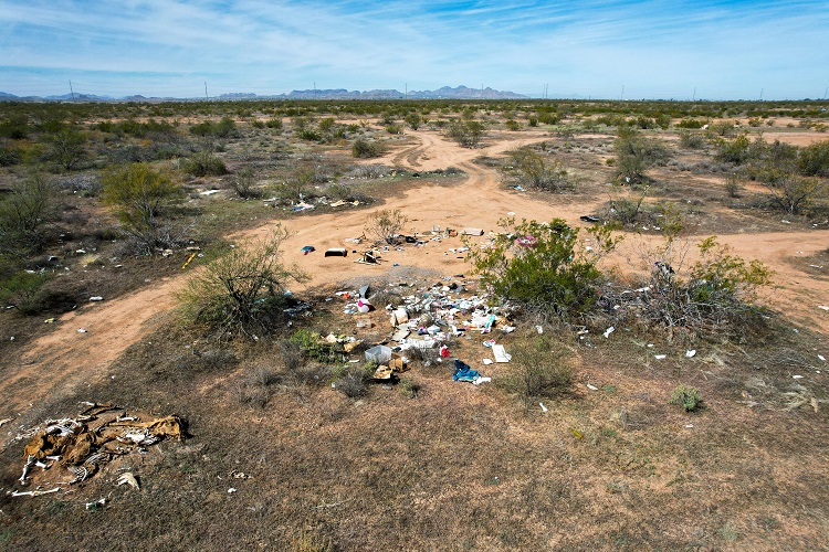 garbage scattered across a desert landscape