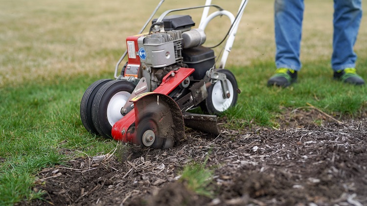lawn edger in use near flower bed