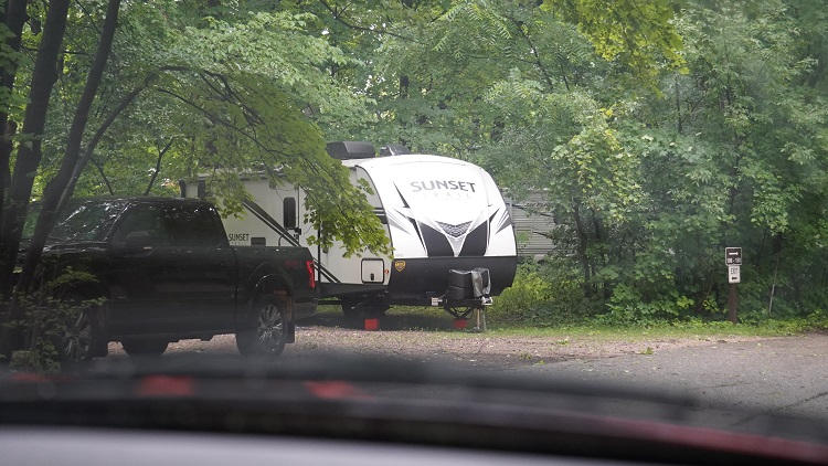 RV trailer in a wooded campground