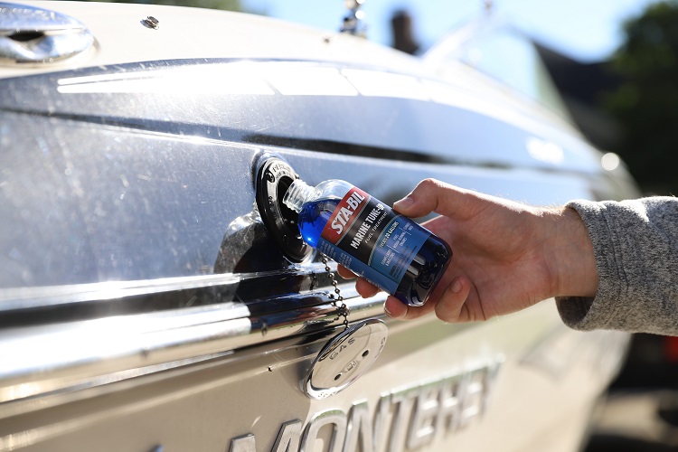 hand pouring STA-BIL Marine Tune-Up in Monterey boat fuel tank