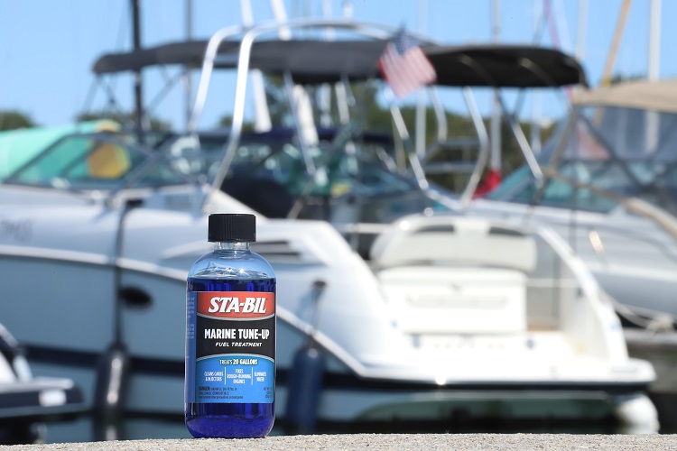 bottle of STA-BIL Marine Tune-Up with speed boat in background