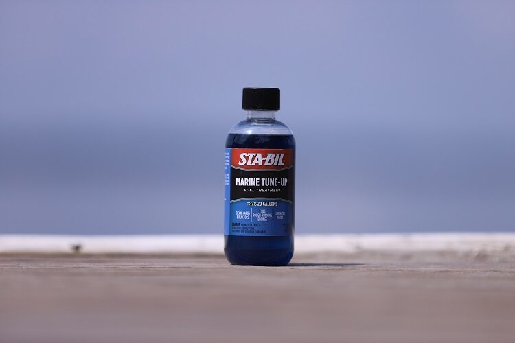 bottle of STA-BIL Marine Tune-Up sitting on dock with ocean in background