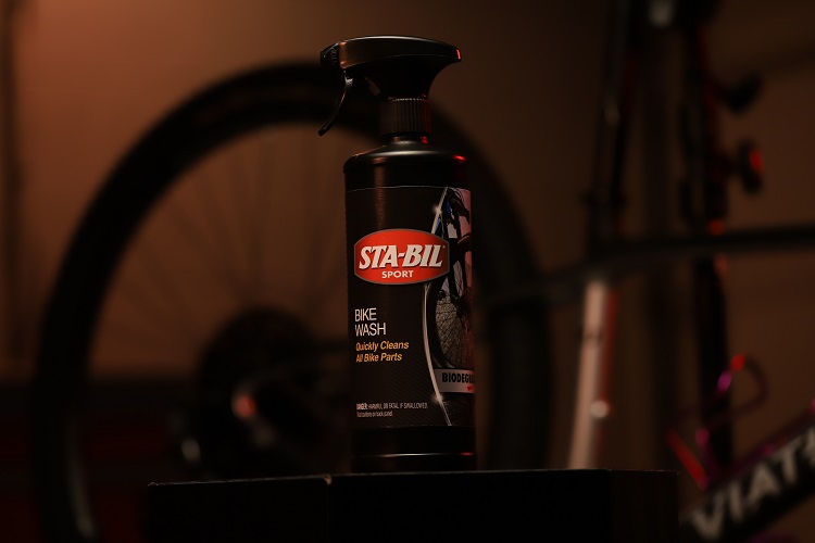 bottle of STA-BIL SPORT Bike Wash with bicycle tire in background