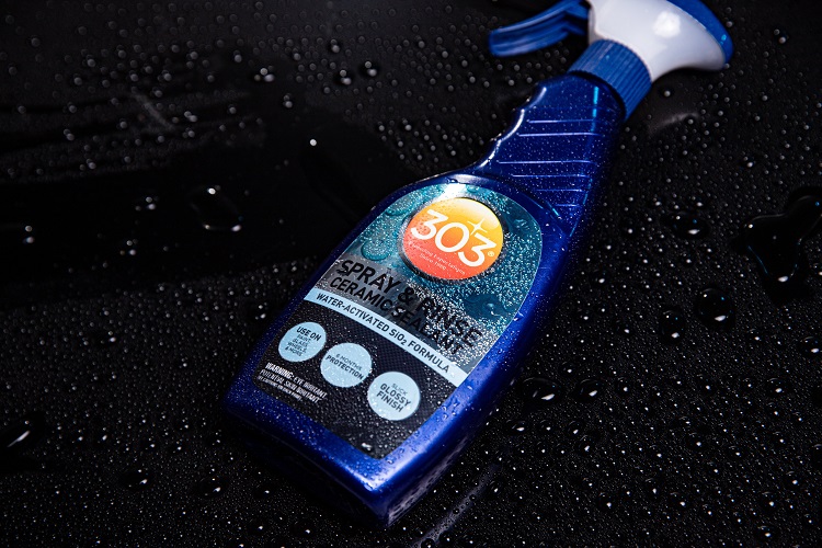 303 spray and rinse ceramic sealant sitting atop of wet car that is visibly wet