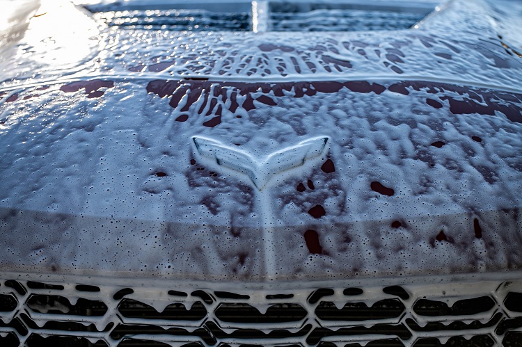 Soap suds dripping down front grille of Chevrolet Corvette