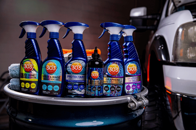 six automotive detailing products displayed on a barrel