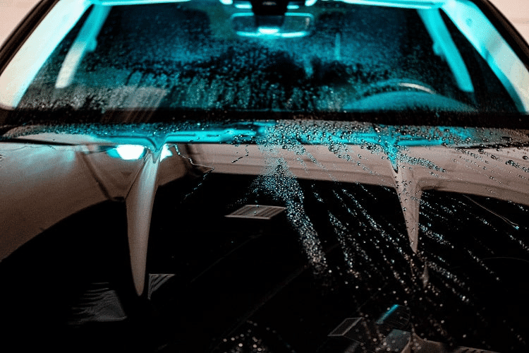 water beading on one half of a car hood