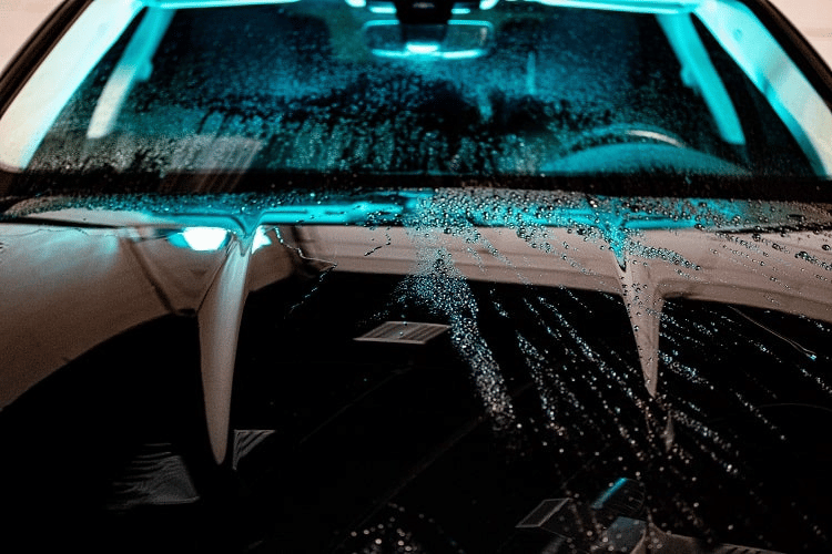 water beading on one half of a car hood