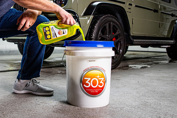 30277 In Use Pouring Wash Into Bucket Garage Floor 1 750x500